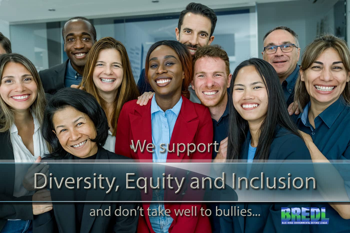 Group of cheerful multiethnic people in formal clothes smiling and looking at camera while standing in modern office